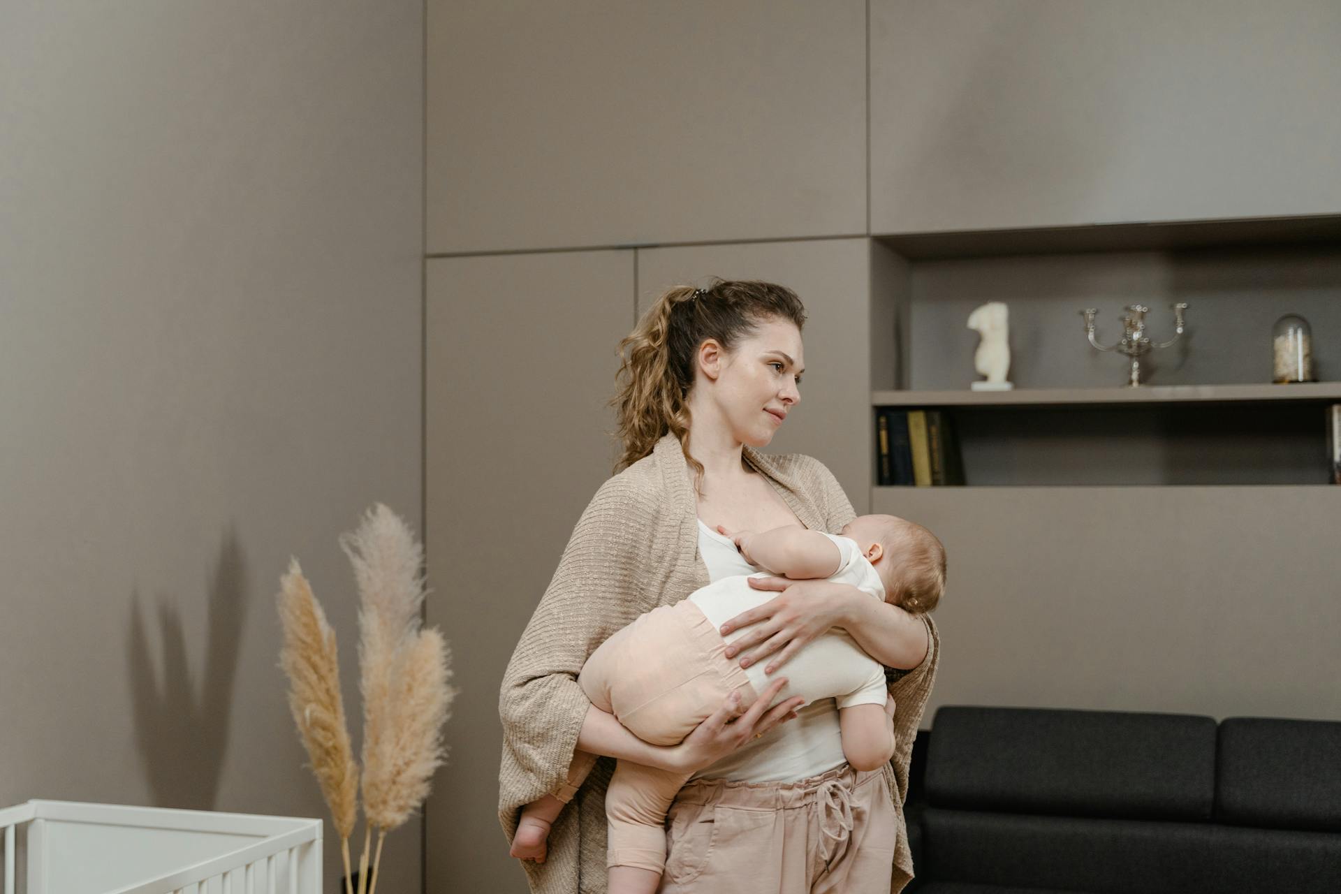 Mother holding baby in warm natural light - Lactovia Care
